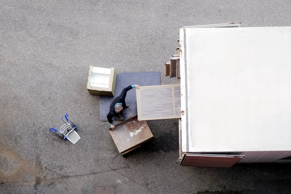 An Aerial View Of A Man Loading Boxes Into A Truck — Greater Newcastle Removals In Rathmines, NSW