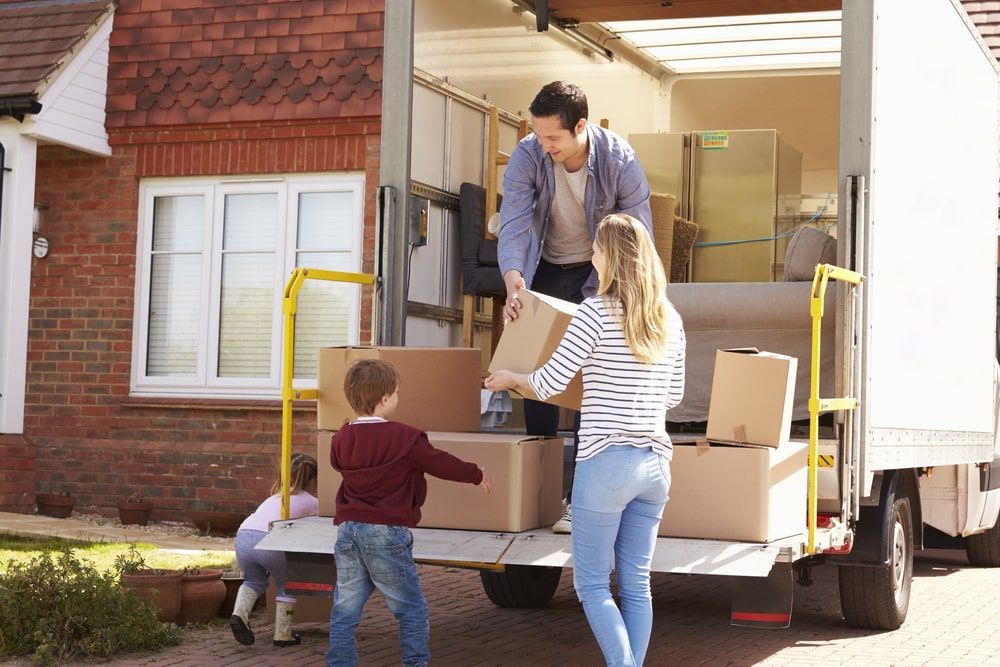 A Family Is Loading Boxes Into A Moving Truck  — Greater Newcastle Removals In Rathmines, NSW