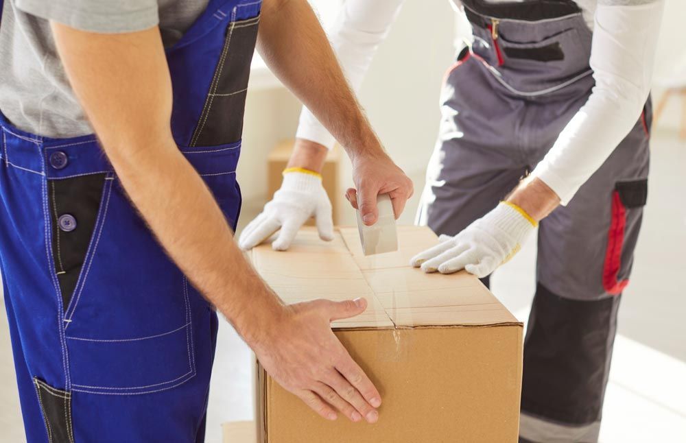 Adding Tape To A Moving Box