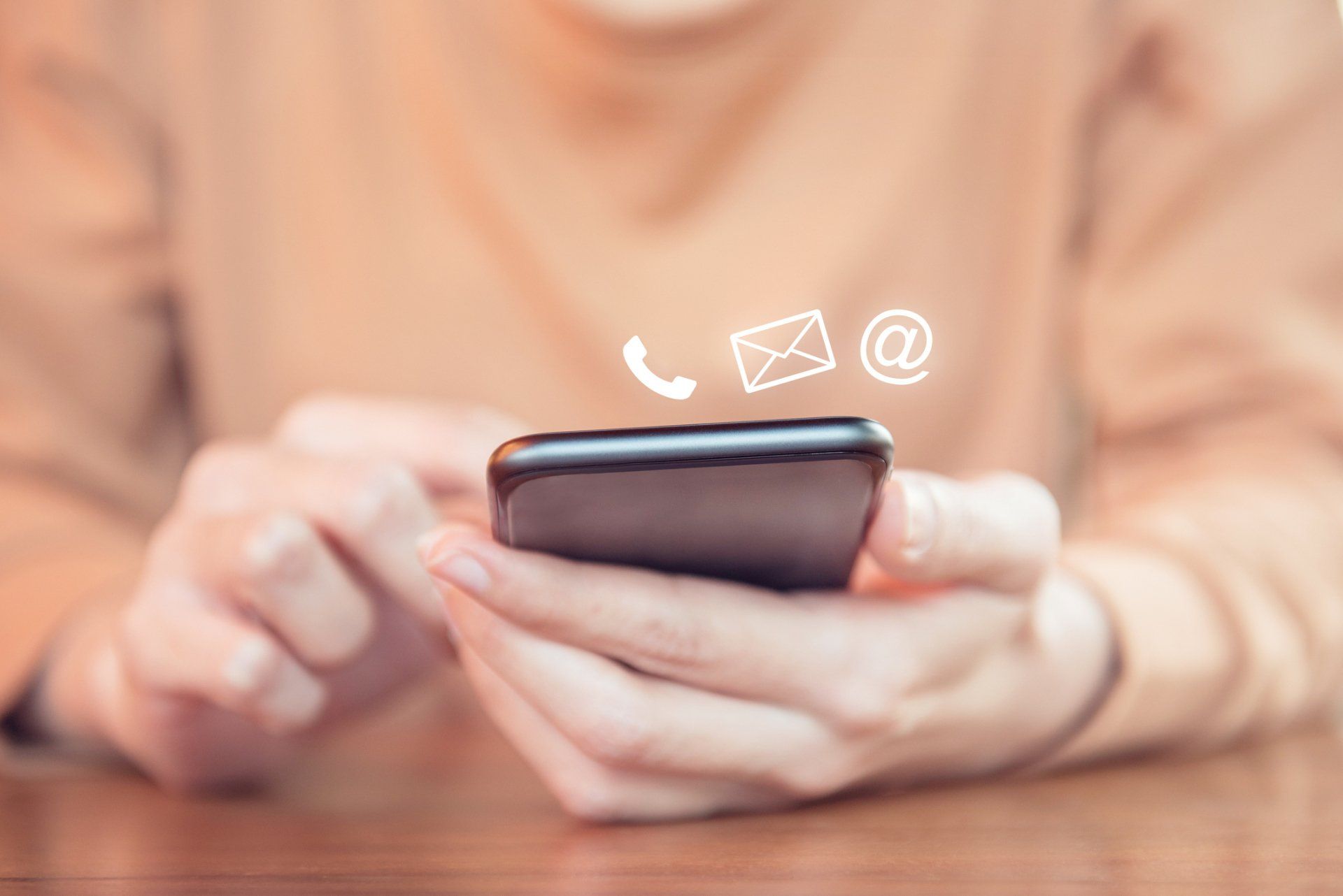 Woman Holding a Phone — Fort Wayne, IN — Arrow Fence