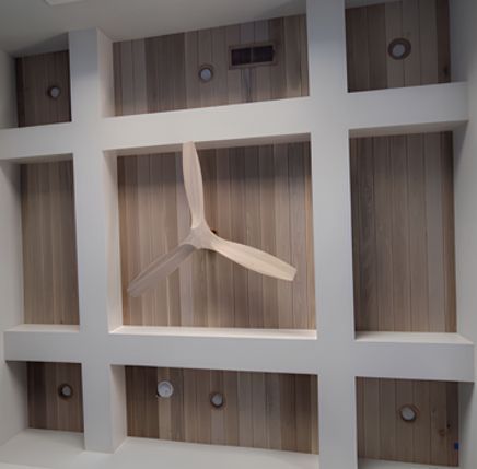 Wooden ceiling with white beams, recessed lighting, and a wooden fan.