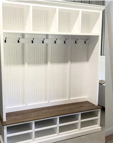 White and brown storage bench with coat hooks and cubbies, built-in style.
