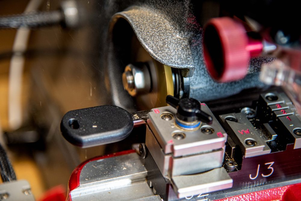 Key-cutting Machine With a Black Key Clamped in Place — Advanced Auto Electrics & Mechanical in Innisfail, QLD