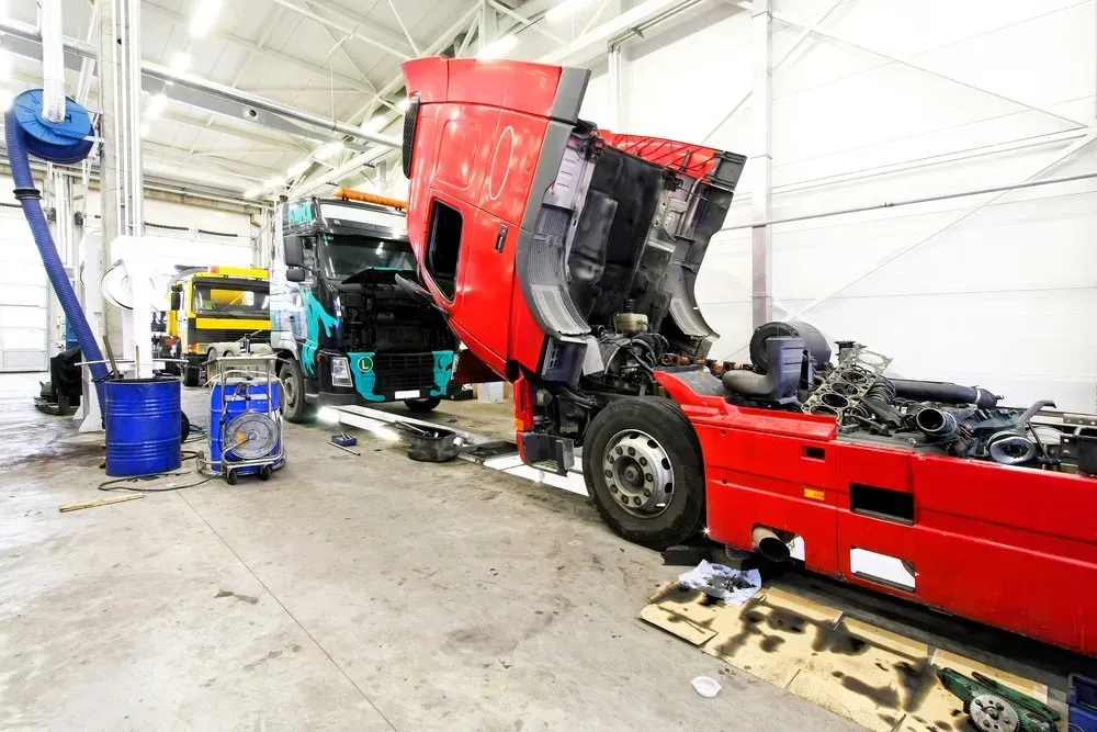 Truck Being Repaired in a Garage. Red Cab is Open, Exposing Engine — Advanced Auto Electrics & Mechanical in Innisfail, QLD