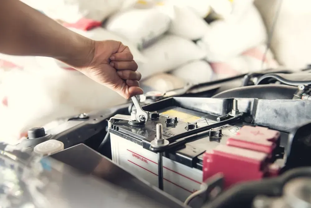 Person's Hand Using a Wrench to Work on a Car Battery  — Advanced Auto Electrics & Mechanical in Innisfail, QLD