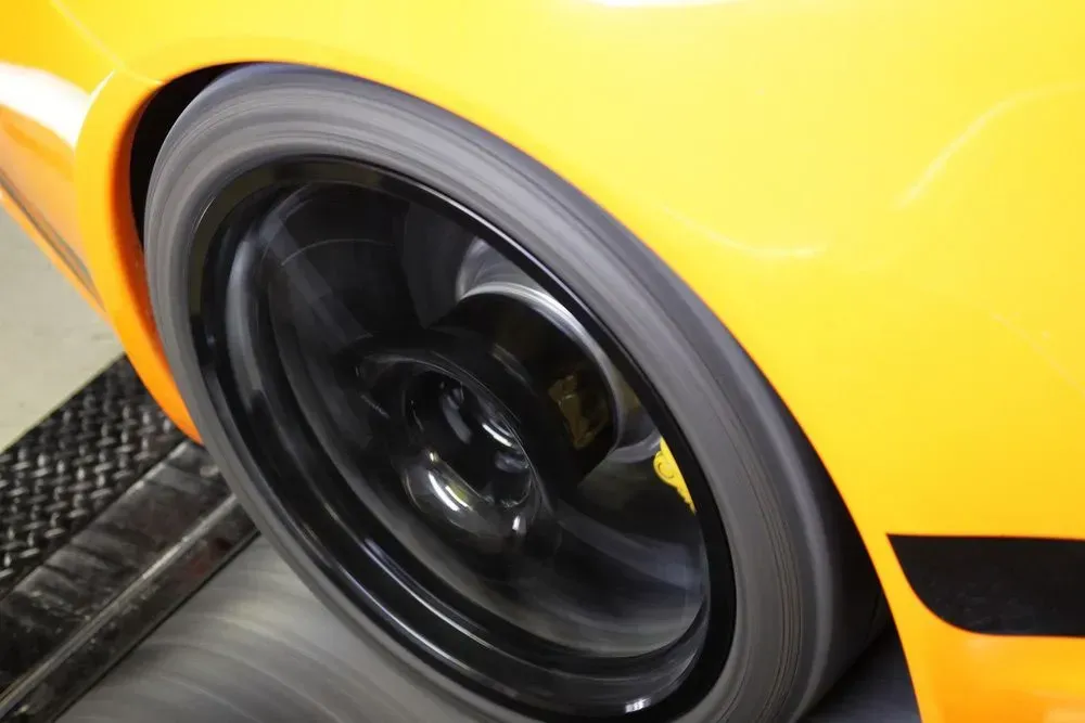 Yellow Car Tire Spinning on a Dyno — Advanced Auto Electrics & Mechanical in Innisfail, QLD
