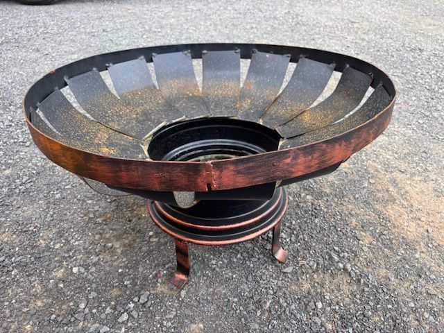 A Fire Pit Made Out of a Tire is Sitting on the Ground — Envy Landscape Supplies In Urangan, QLD