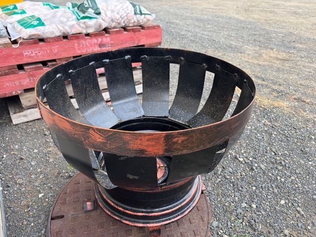 A Fire Pit Made Out of a Tire is Sitting on Top of a Manhole Cover — Envy Landscape Supplies In Urangan, QLD