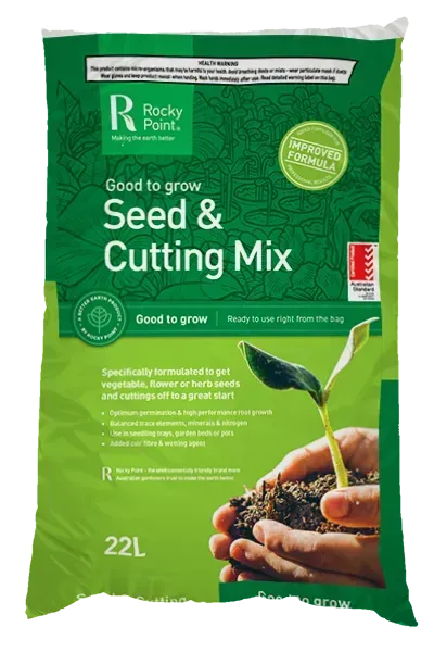 A Bag of Seed and Cutting Mix is Sitting on a Wooden Table — Envy Landscape Supplies In Urangan, QLD