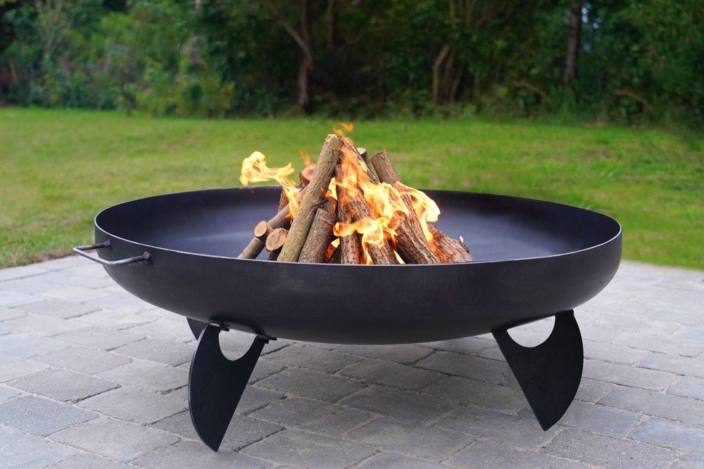 A Fire Pit With Wood That is Burning in the Middle — Envy Landscape Supplies In Urangan, QLD