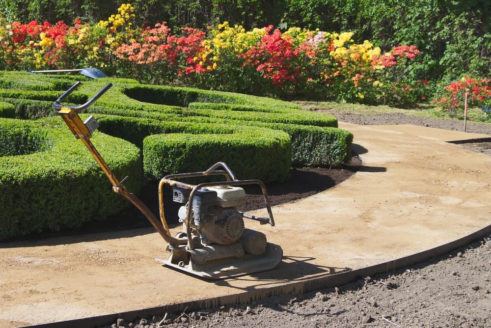 A Machine Is Being Used To Level A Path In A Garden — Envy Landscape Supplies In Urangan, QLD