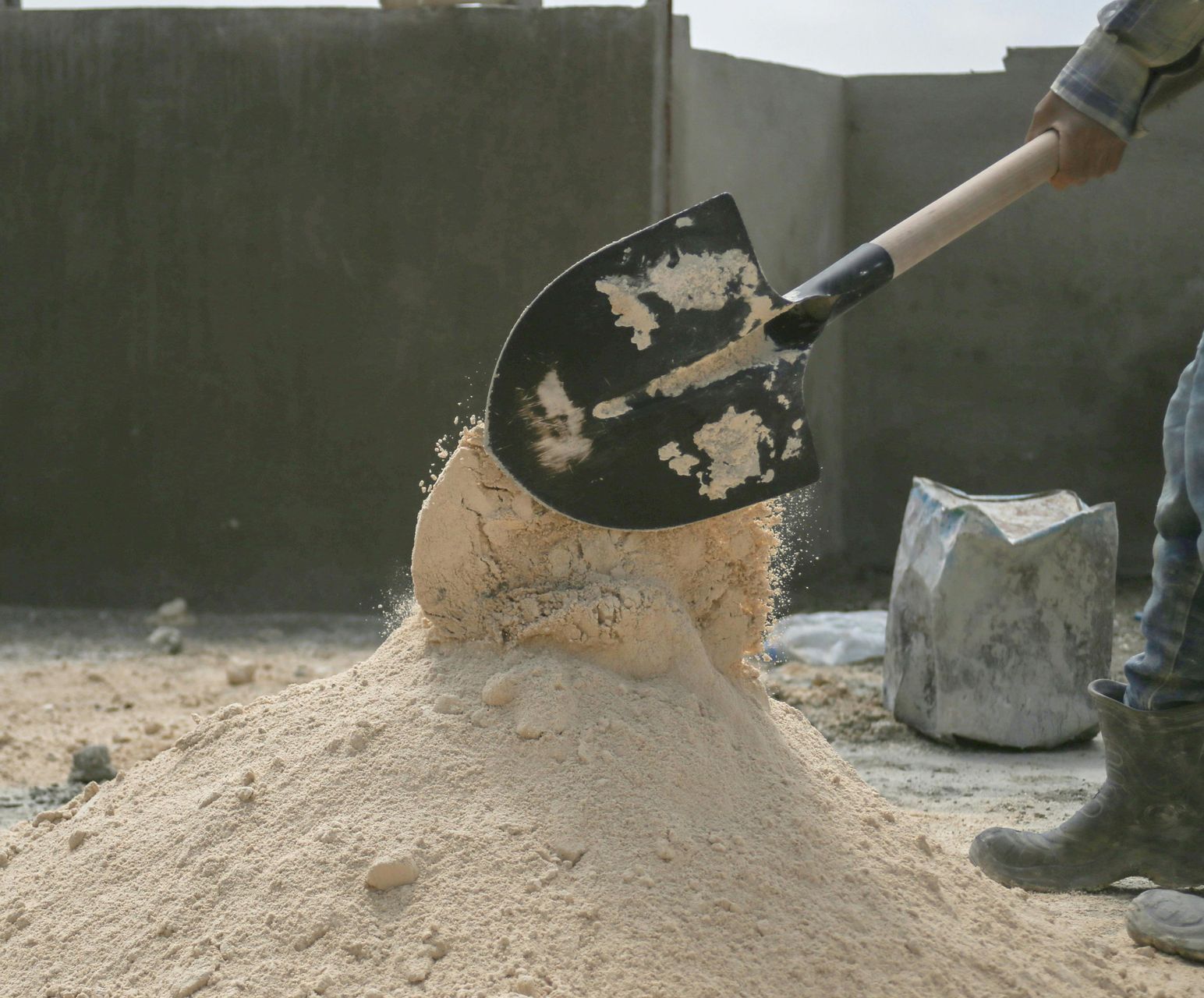 A Man Shoveling Sand — Envy Landscape Supplies In Urangan, QLD