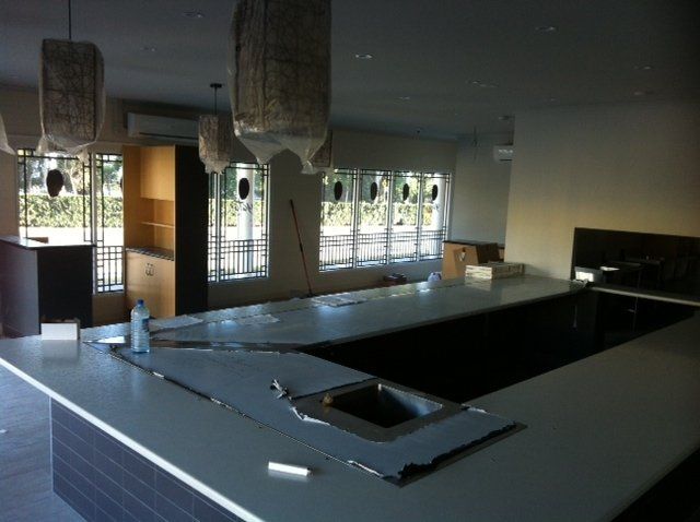 A kitchen with a large counter top and a sink — Red Emperor Constructions in Cannonvale, QLD