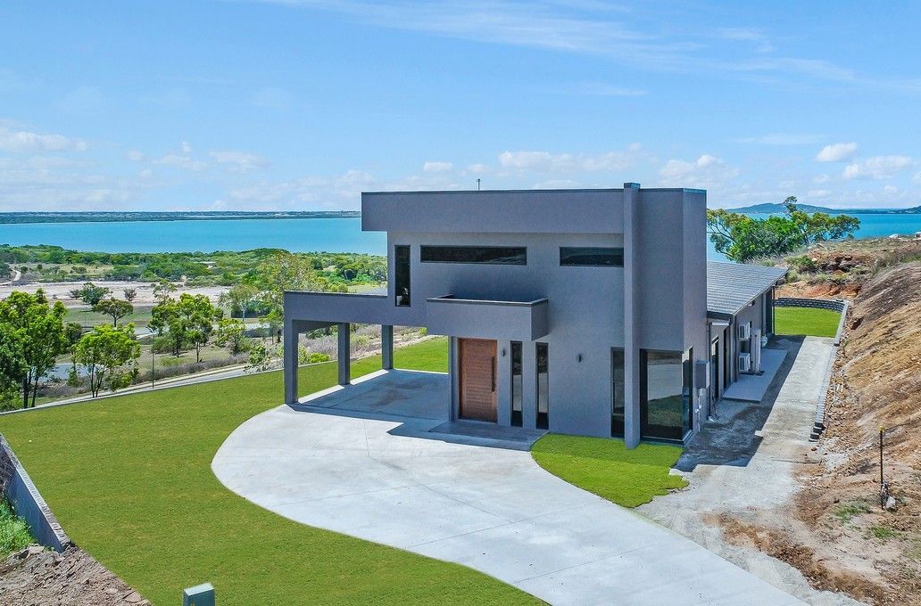 Modern Gray House With Ocean View, Driveway, and Green Lawn — Red Emperor Constructions in Cannonvale, QLD