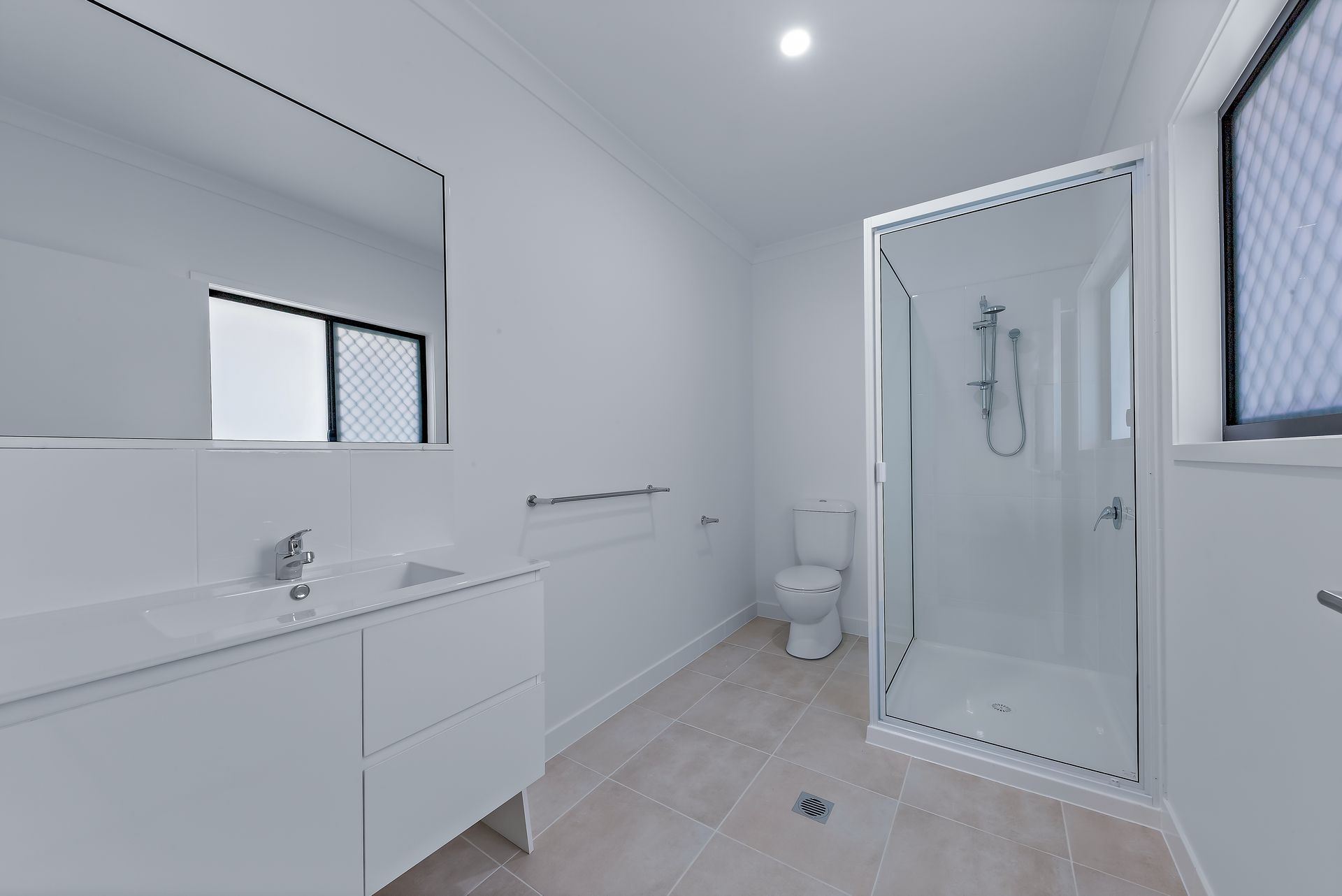 Bright White Modern Bathroom With a Shower Stall, Toilet — Red Emperor Constructions in Cannonvale, QLD