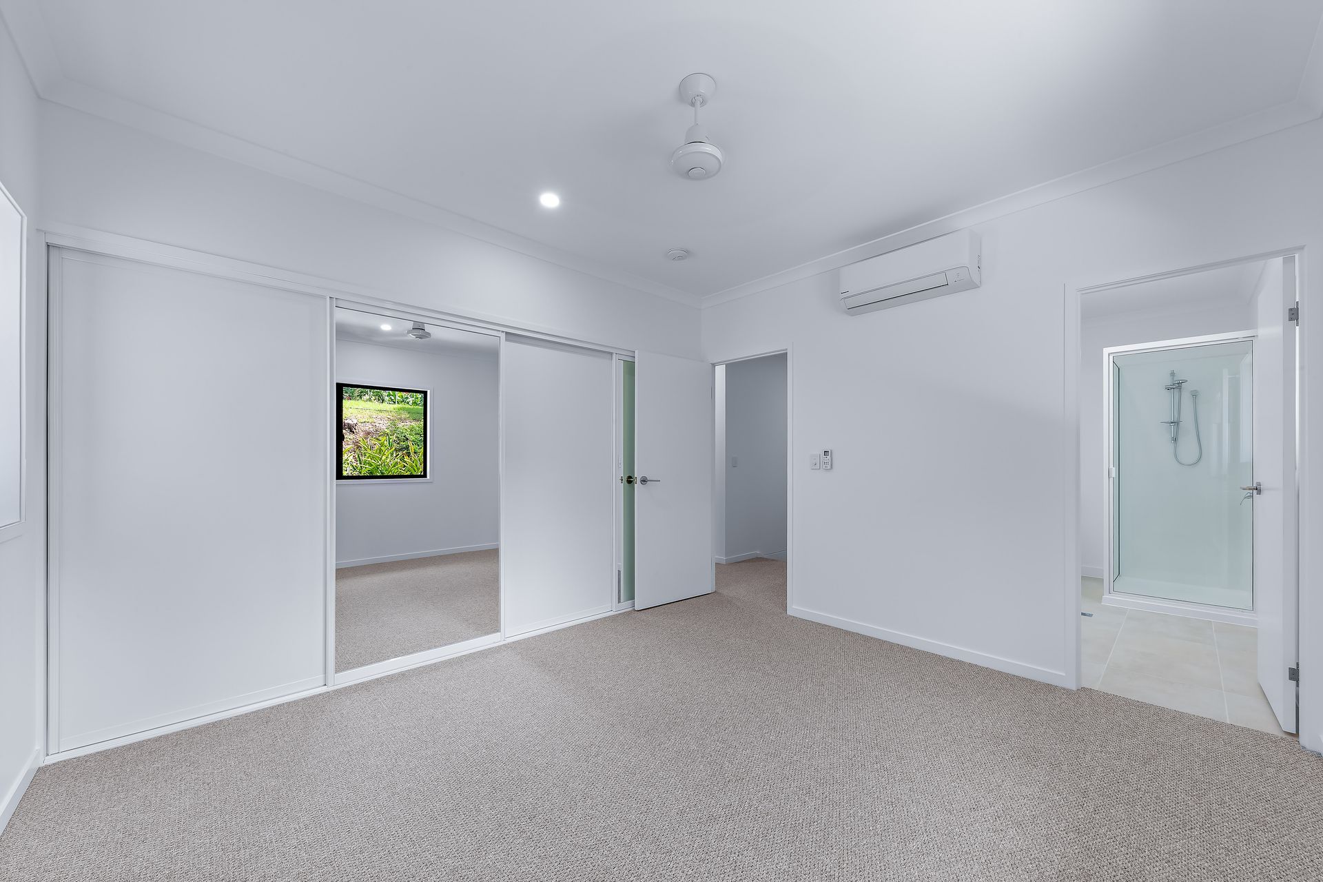 Empty White Bedroom With Carpet, Open Doors to Other Rooms — Red Emperor Constructions in Cannonvale, QLD