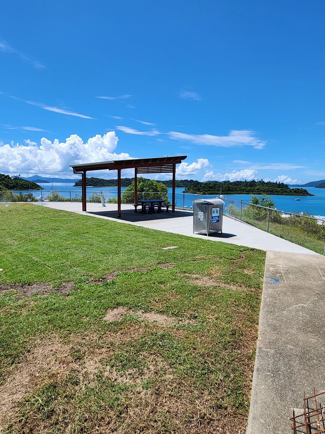A picnic area with a shelter overlooking the ocean on a sunny day — Red Emperor Constructions in Cannonvale, QLD