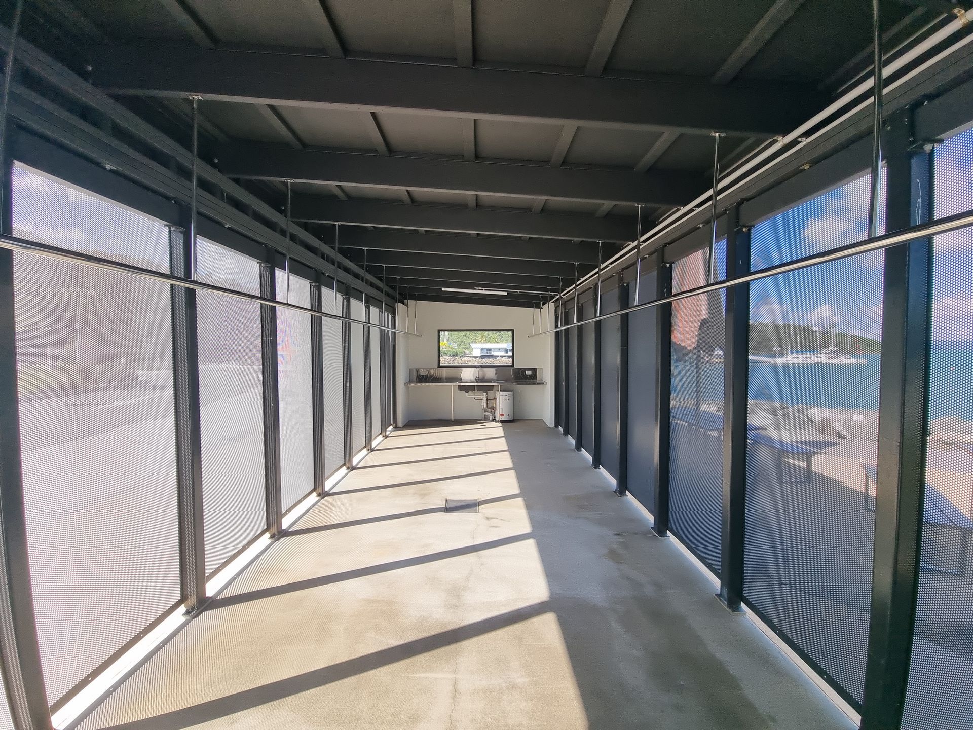 A long hallway with a lot of windows and a window in the middle — Red Emperor Constructions in Cannonvale, QLD