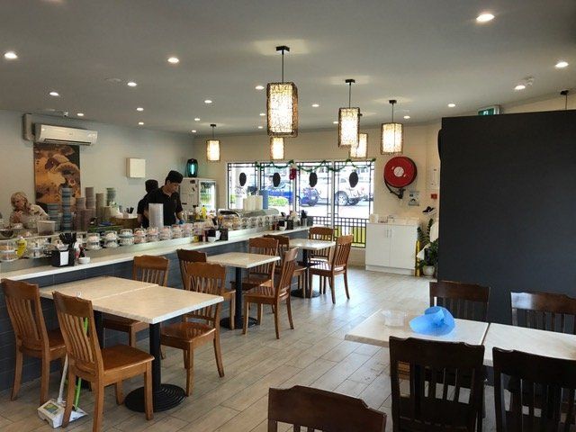 The inside of a restaurant with tables and chairs — Red Emperor Constructions in Cannonvale, QLD
