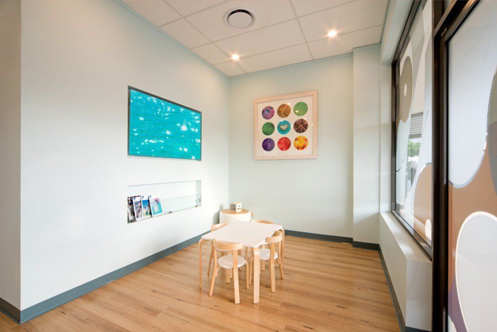 There is a table and chairs in the room — Red Emperor Constructions in Cannonvale, QLD