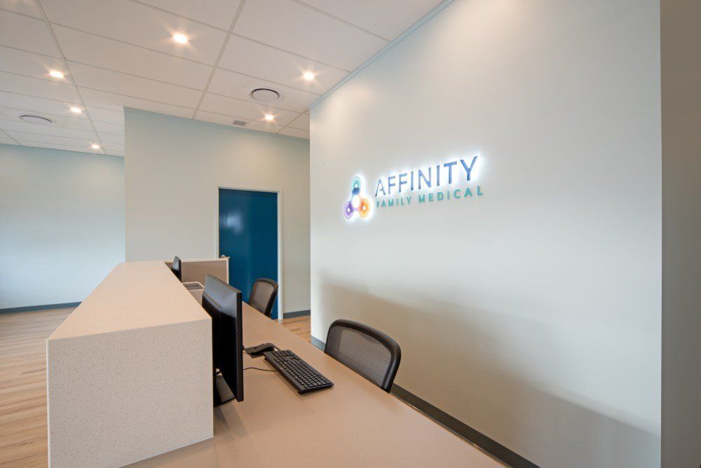A reception desk with a computer on it in a medical office — Red Emperor Constructions in Cannonvale, QLD