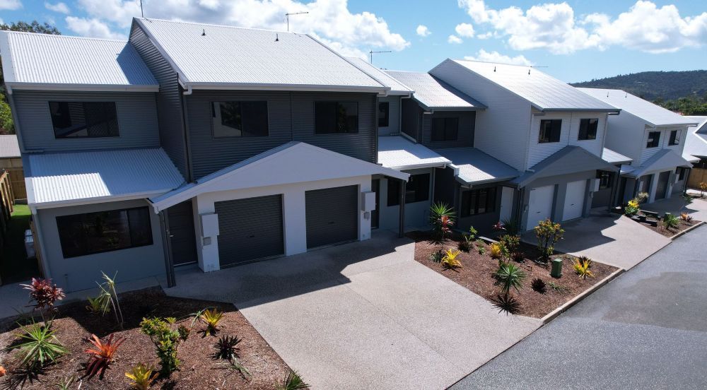 An Aerial View of a Row of Houses on a Sunny Day — Red Emperor Constructions in Cannonvale, QLD