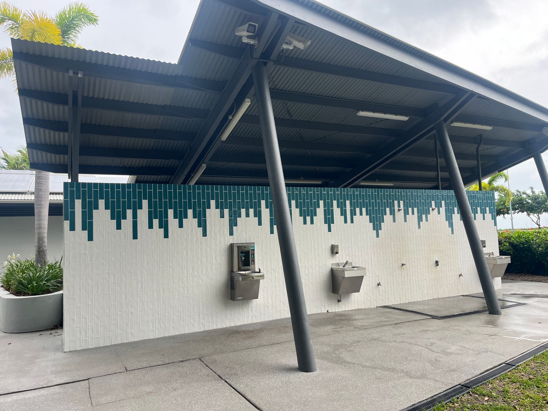 Public Water Fountain Area With Gray Roof, Teal and White Wall, and Gray Posts — Red Emperor Constructions in Cannonvale, QLD