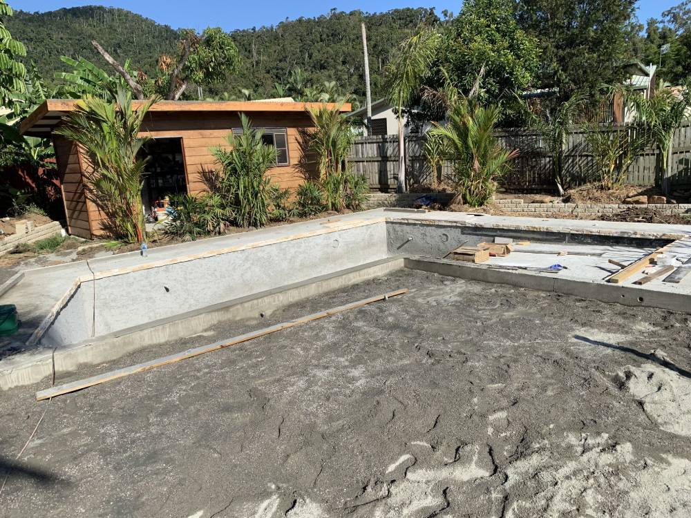 A swimming pool is being built in the backyard of a house — Red Emperor Constructions in Cannonvale, QLD