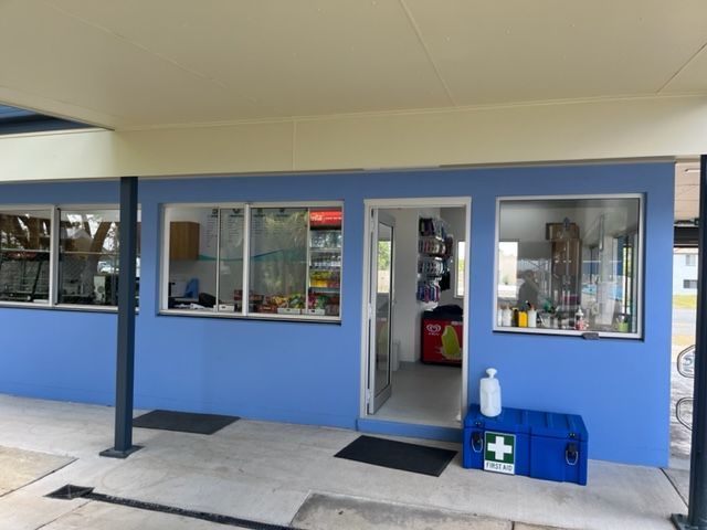 A blue building with a first aid box in front of it — Red Emperor Constructions in Cannonvale, QLD