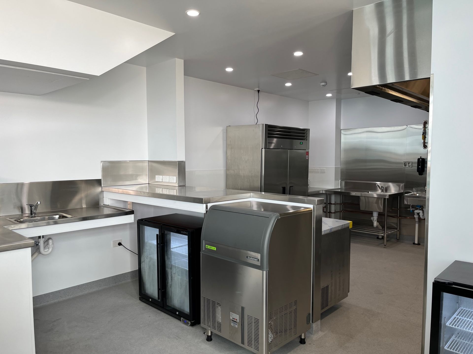 Commercial Kitchen With Stainless Steel Appliances and a Freezer — Red Emperor Constructions in Cannonvale, QLD