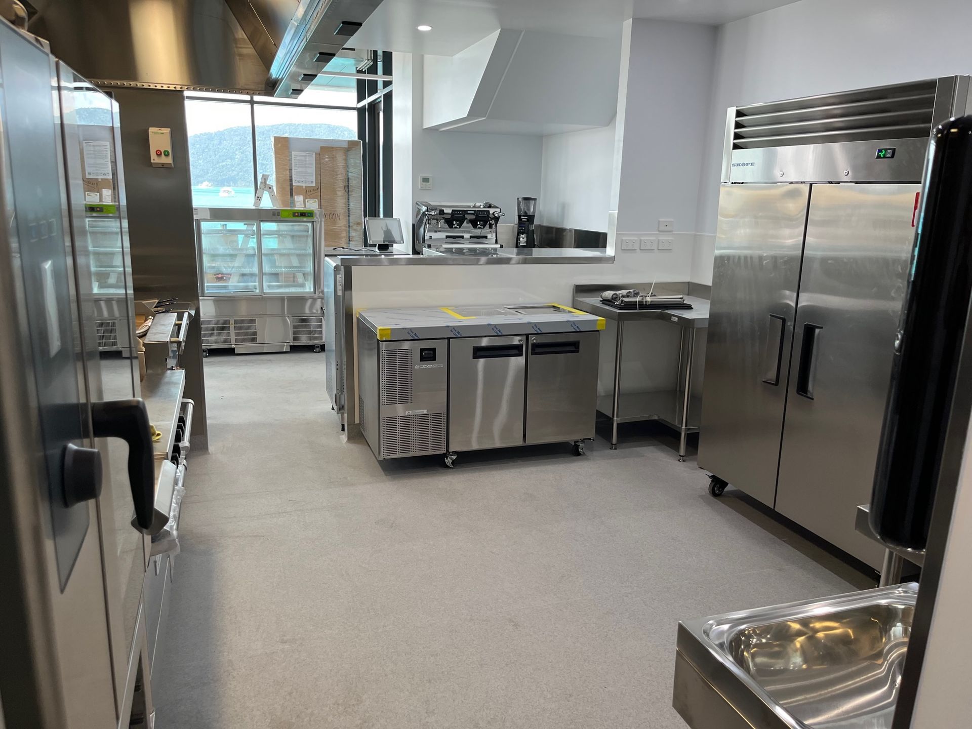 A Stainless Steel Commercial Kitchen With Appliances — Red Emperor Constructions in Cannonvale, QLD