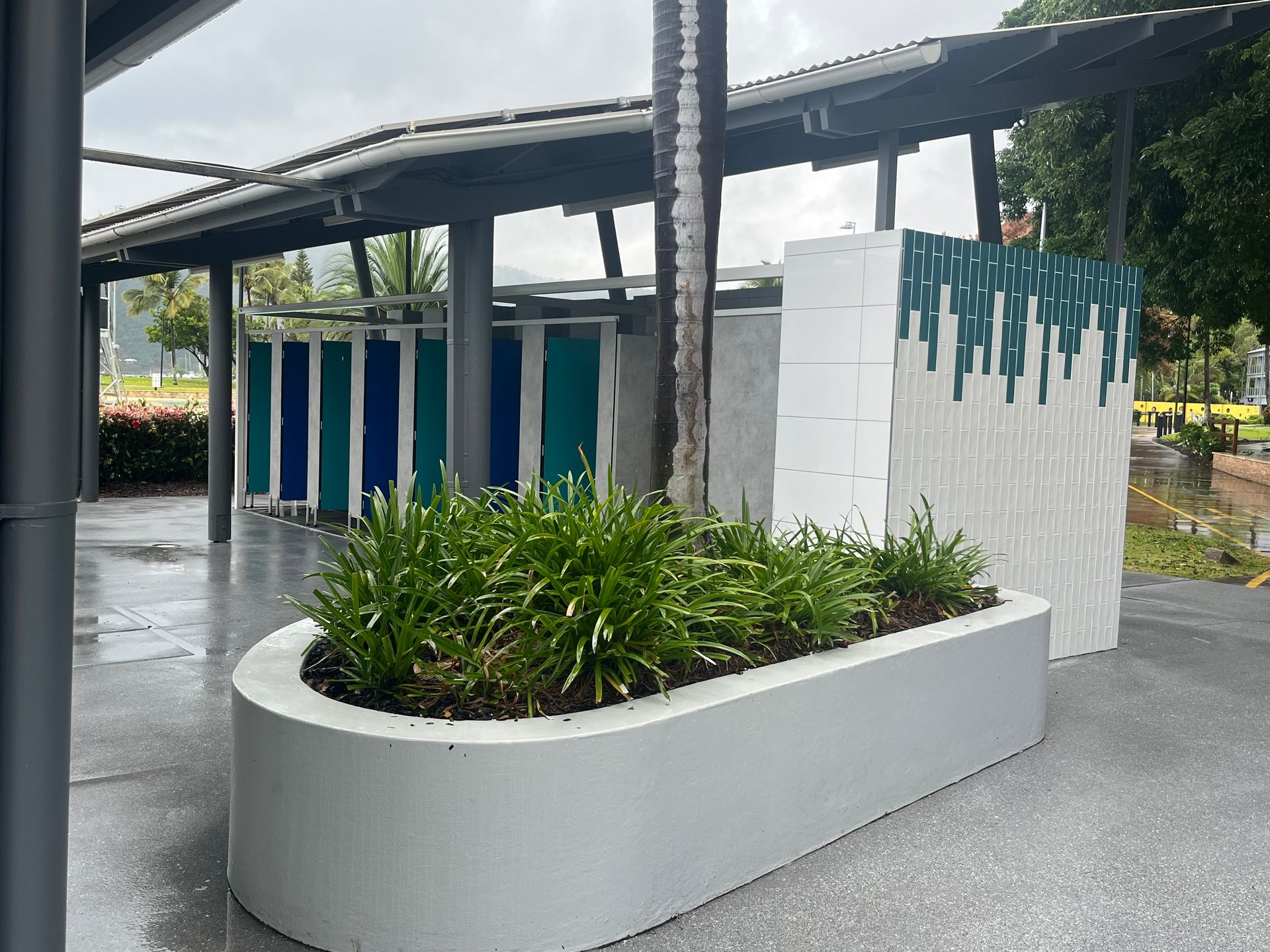 Public Restrooms With a Planter in Front, Beneath a Covered Walkway — Red Emperor Constructions in Cannonvale, QLD