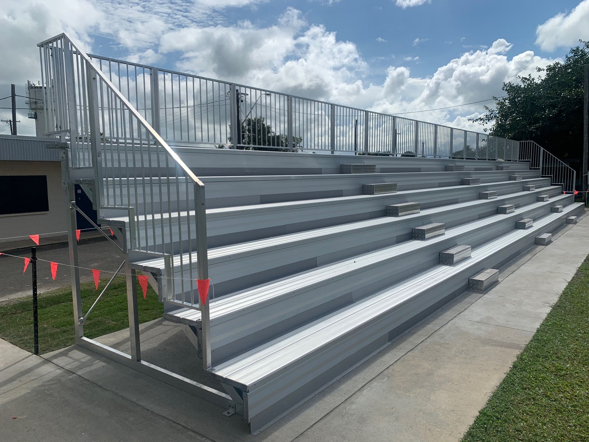 A bleacher with stairs and a railing on a sunny day — Red Emperor Constructions in Cannonvale, QLD