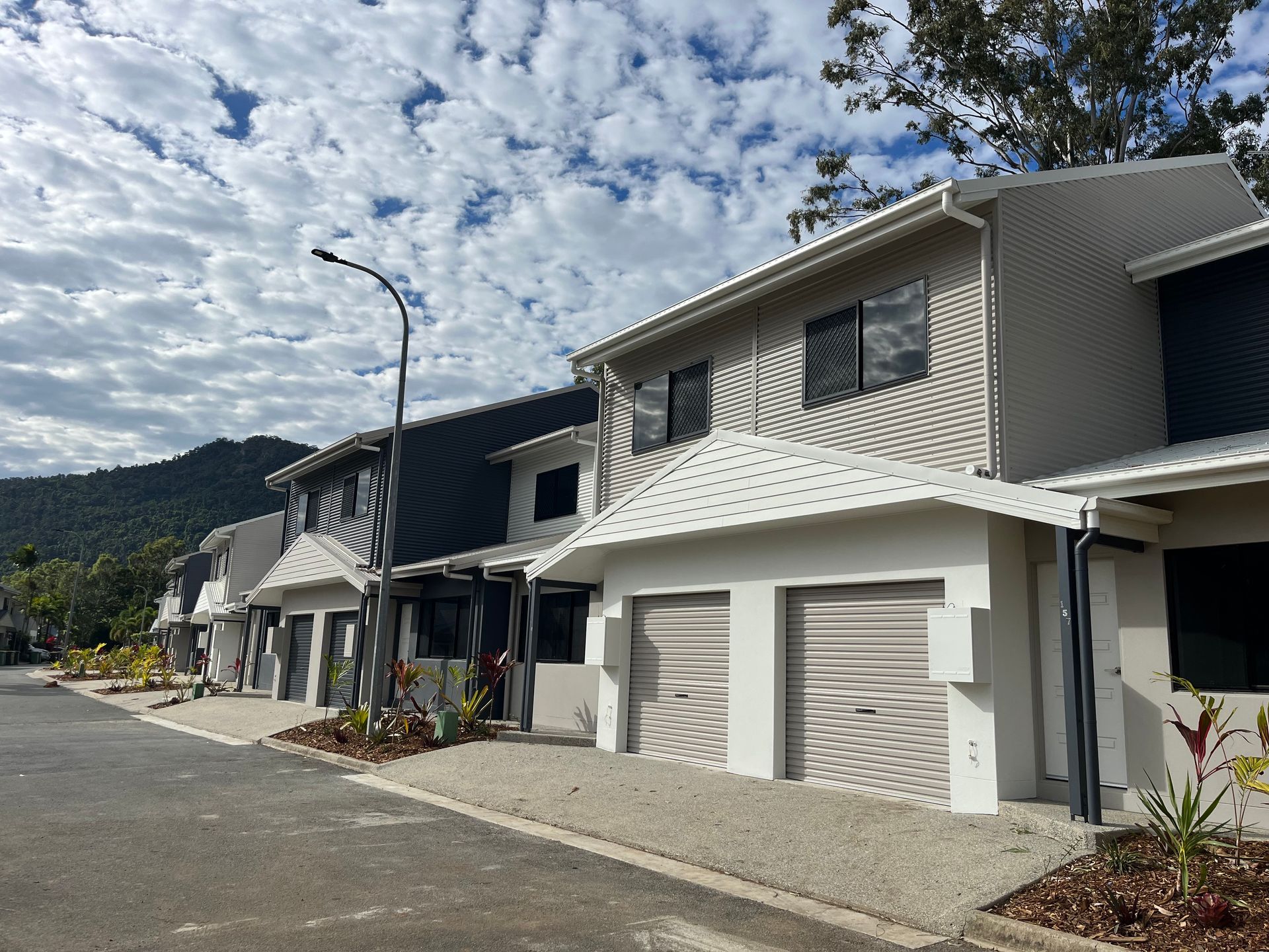 Townhouses With Grey and White Exteriors, Light-colored Garage Doors — Red Emperor Constructions in Cannonvale, QLD