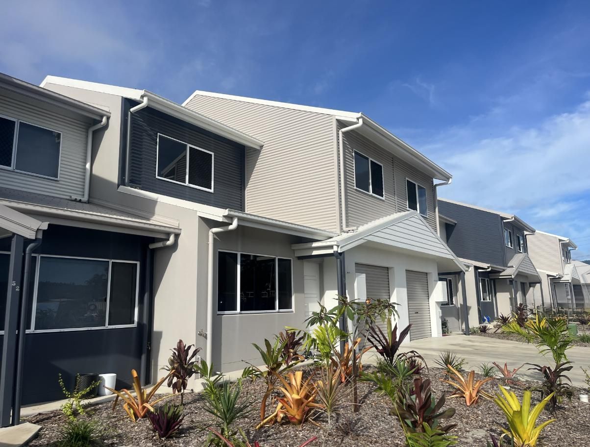 Row of Modern Townhouses With Gray and White Siding — Red Emperor Constructions in Cannonvale, QLD