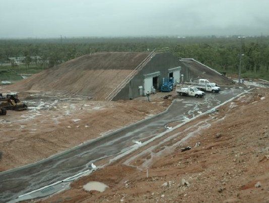 A large building is sitting on top of a dirt hill — Red Emperor Constructions in Cannonvale, QLD