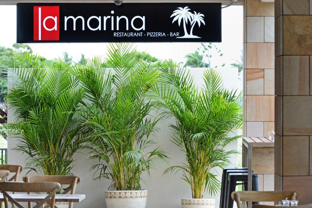 A restaurant with a sign that says la marina — Red Emperor Constructions in Cannonvale, QLD