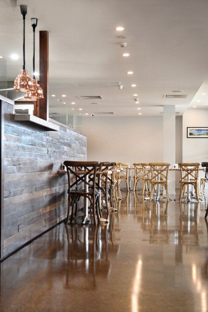 A restaurant with tables and chairs and a bar — Red Emperor Constructions in Cannonvale, QLD