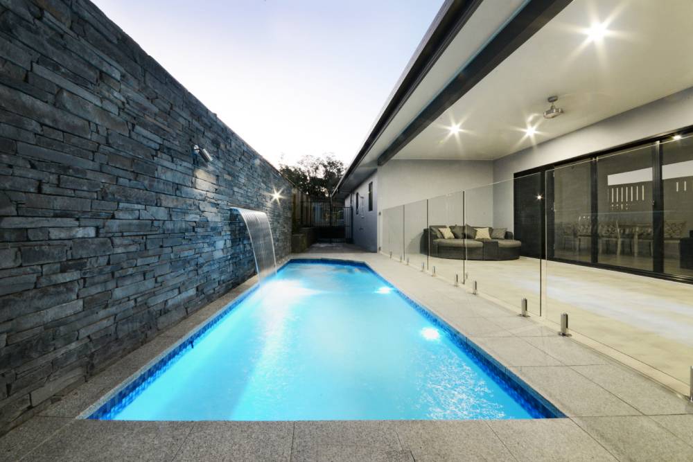 A large swimming pool in the backyard of a house — Red Emperor Constructions in Cannonvale, QLD
