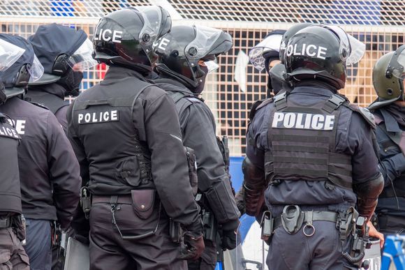 A group of police officers are standing next to each other.