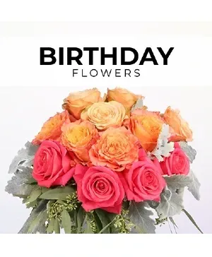 Birthday flowers: a bouquet of orange and pink roses with foliage on a white background.