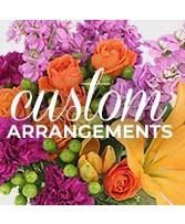 Colorful floral arrangement with 'Custom Arrangements' text overlay.