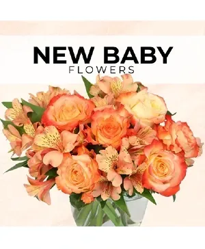 Orange roses and lilies bouquet in a clear vase, for a new baby.