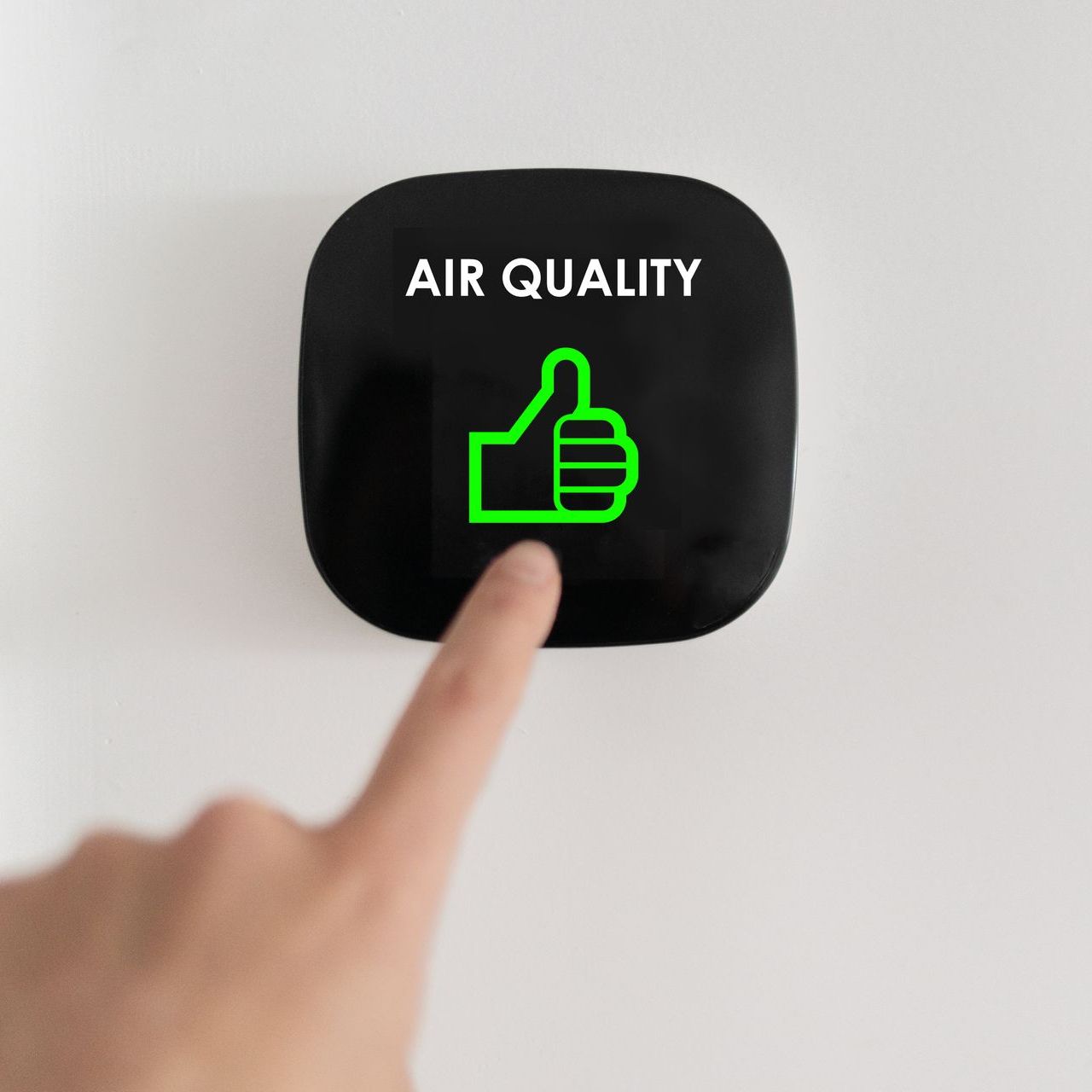A person is pressing a button that says air quality