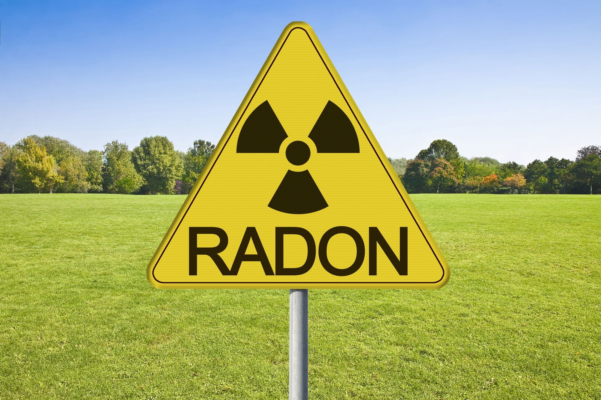 A yellow sign that says radon in a field