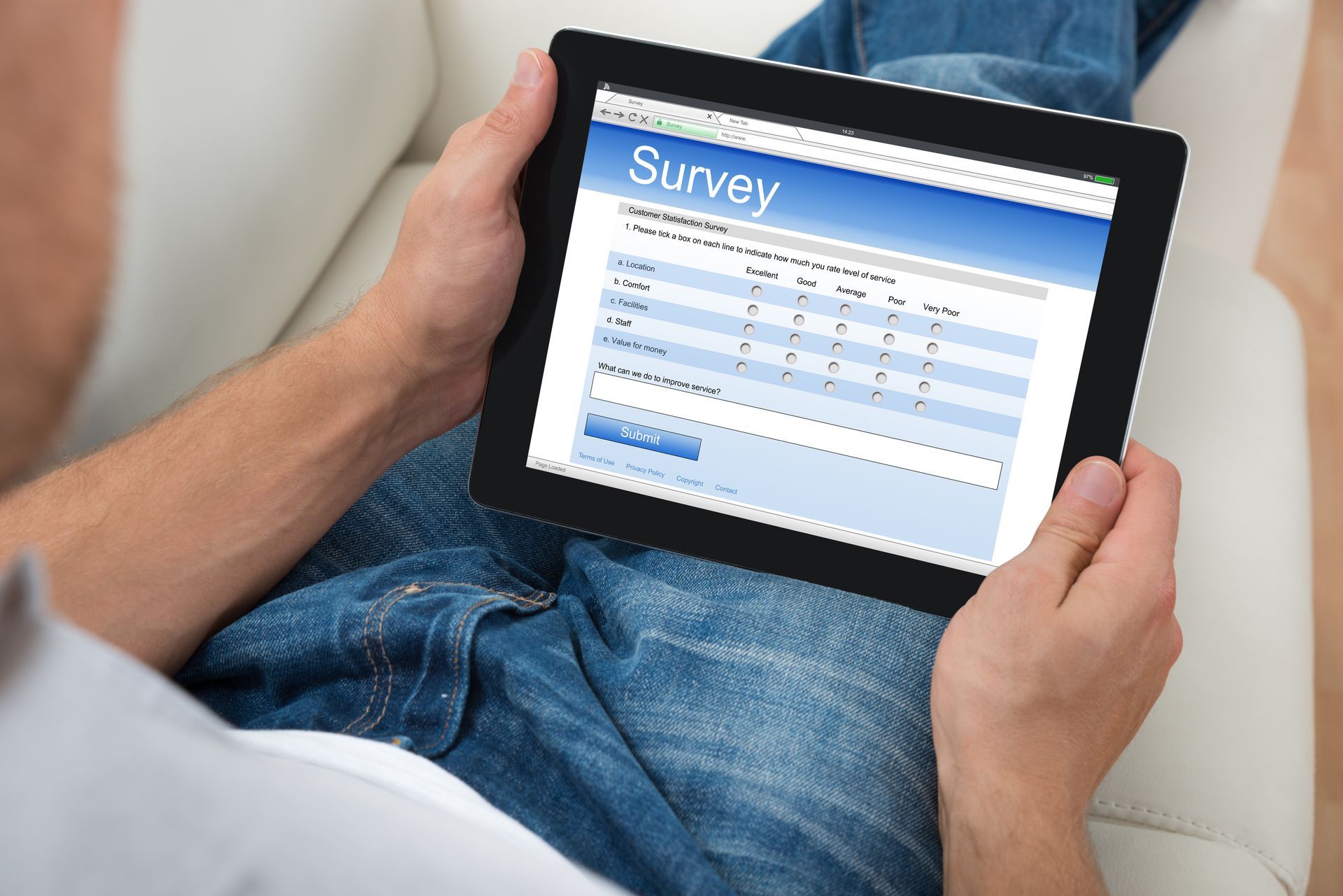 A man is using a tablet to fill out a survey