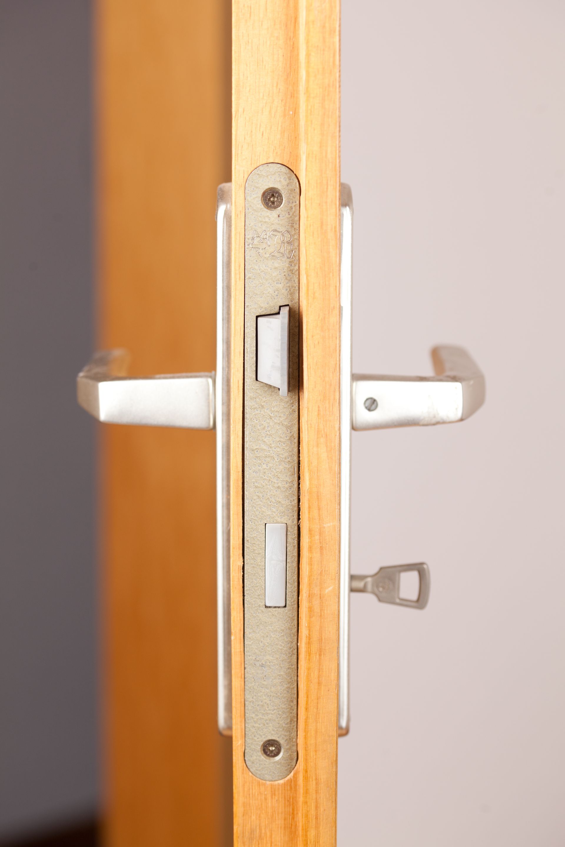 A close up of a door lock on a wooden door