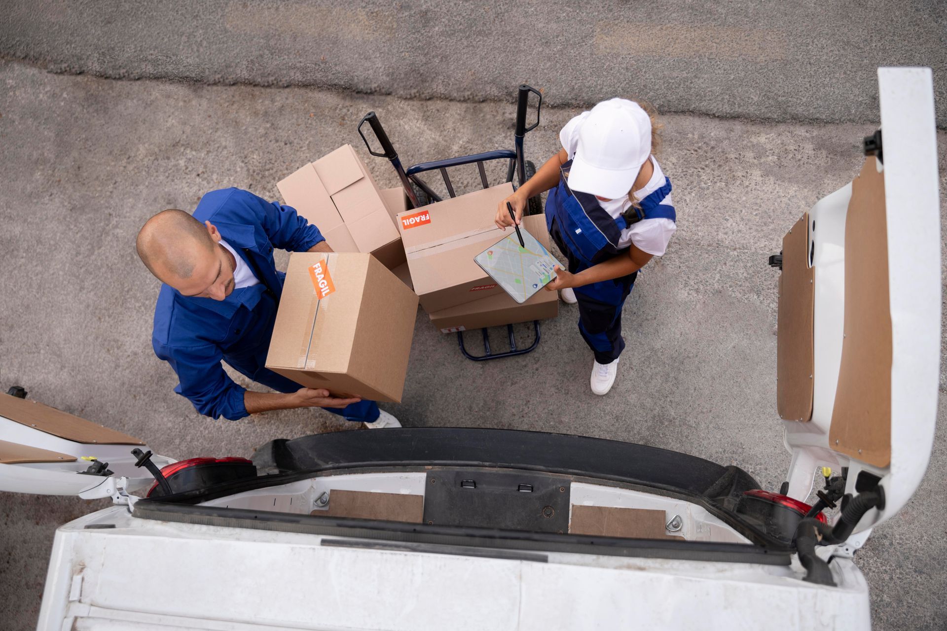 A man and a woman are loading boxes into a van.