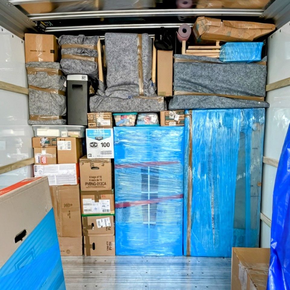 The inside of a moving truck filled with boxes and a sign that says cd 700