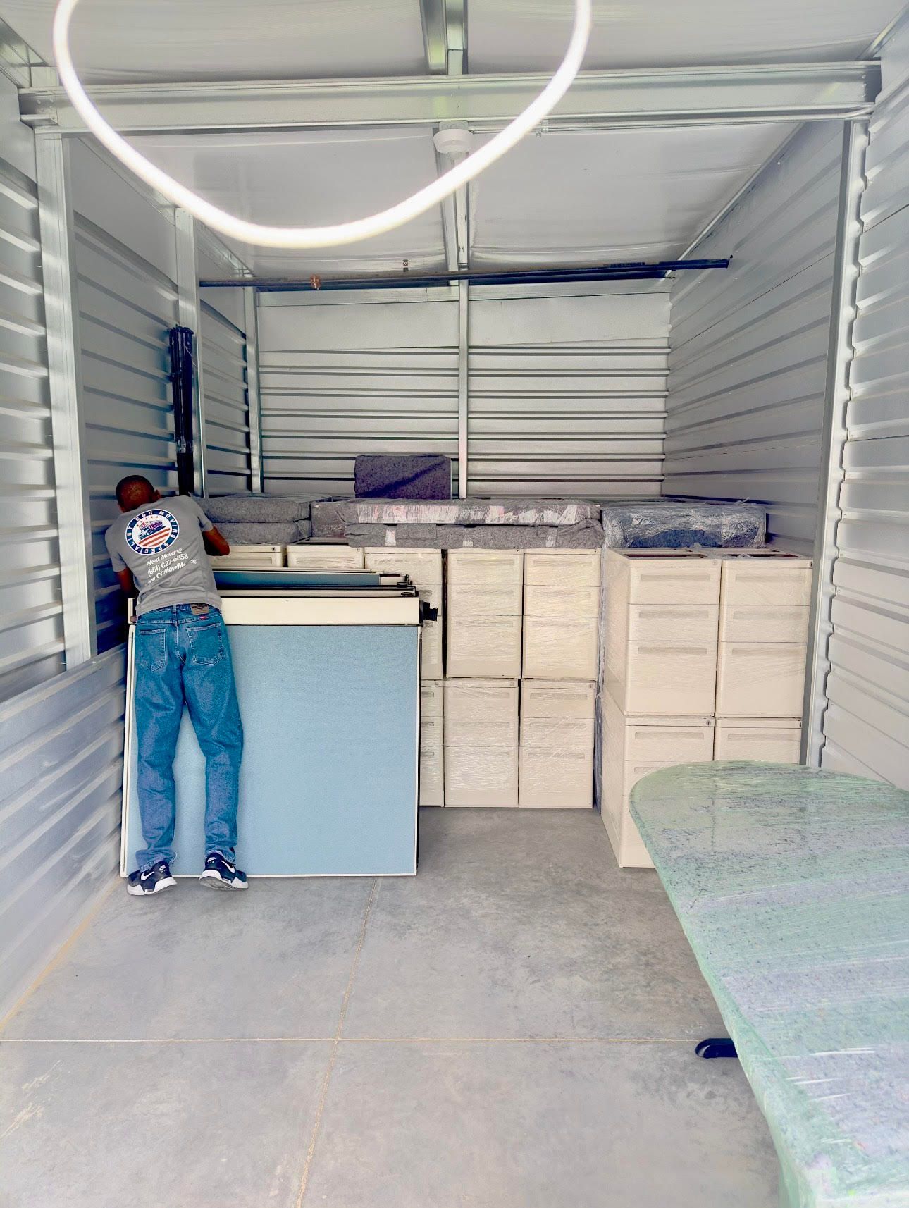 A warehouse filled with boxes and a sliding glass door.